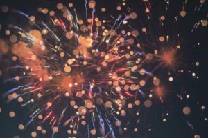Neon orange firework sparks shot at night
