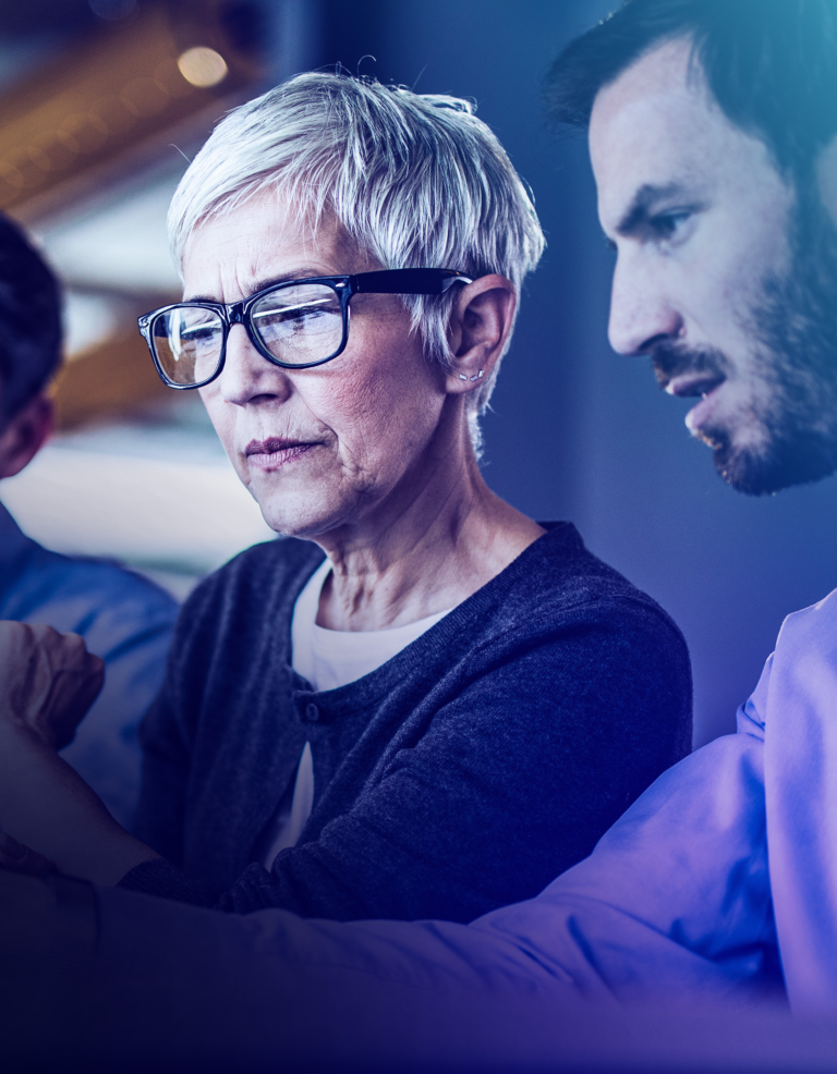 Female professional in glasses interacting with male colleague in meeting