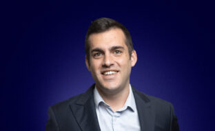 Tommaso Lugli, Head of Research and Strategic Accounts, dressed in a dark suit and smiling