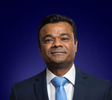 Snehal Wadhar, Chief Financial Officer, dressed in a suit and blue tie, smiling
