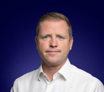 Paul Marshall, Head of IT, dressed in a white shirt and smiling at the camera