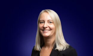 Helen Saunders, Chief Solutions Officer, a blonde professional dressed in smart clothing