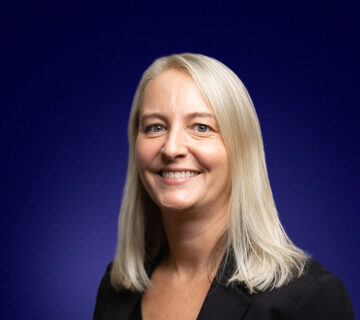 Helen Saunders, Chief Solutions Officer, a blonde professional dressed in smart clothing