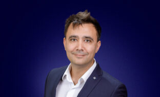 Dragos Tomescu, Head of Delivery Operations, a dark-haired man dressed smartly, smiling at the camera