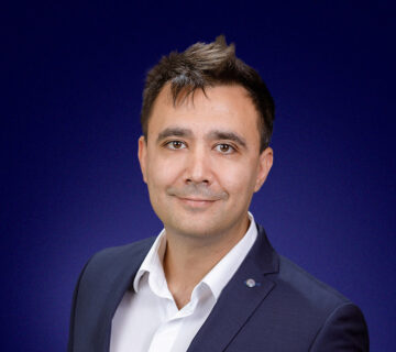 Dragos Tomescu, Head of Delivery Operations, a dark-haired man dressed smartly, smiling at the camera