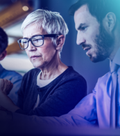Female professional in glasses interacting with male colleague in meeting