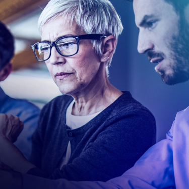 Female professional in glasses interacting with male colleague in meeting