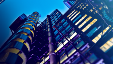 City skyscraper scaled from below at night, deep purple lighting