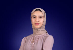 Headshot of Imane Jalal in front of blue background